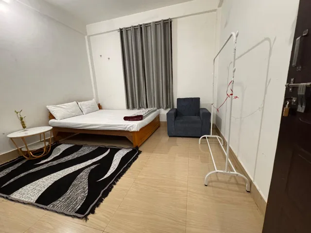 Room interior with an armchair and clothes stand